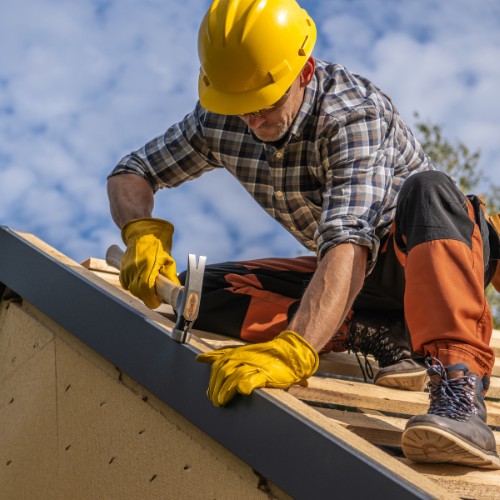 Roofing contractor installing a new roof